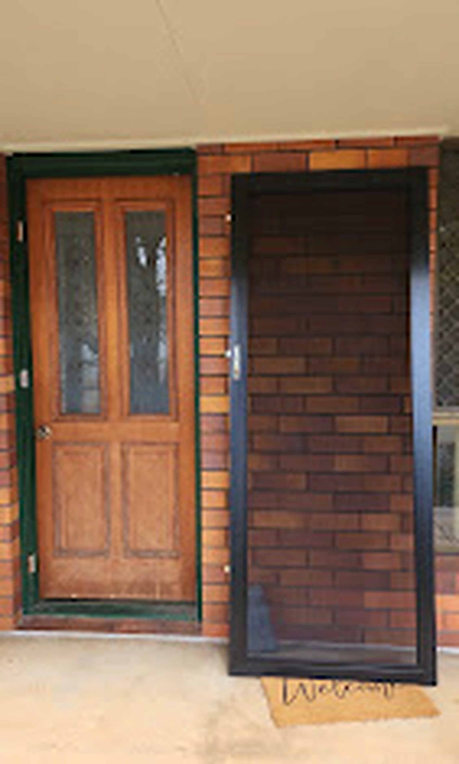 Traditional entry with a newly fitted dark security door