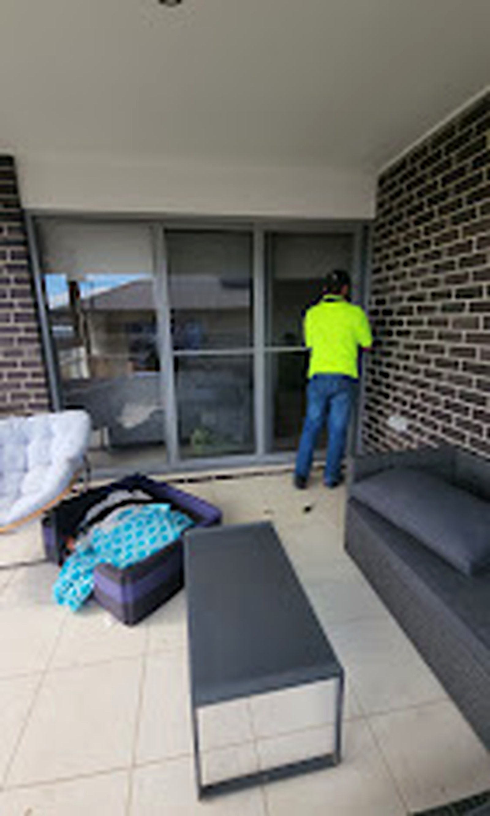 Installer measuring a wide patio doorway