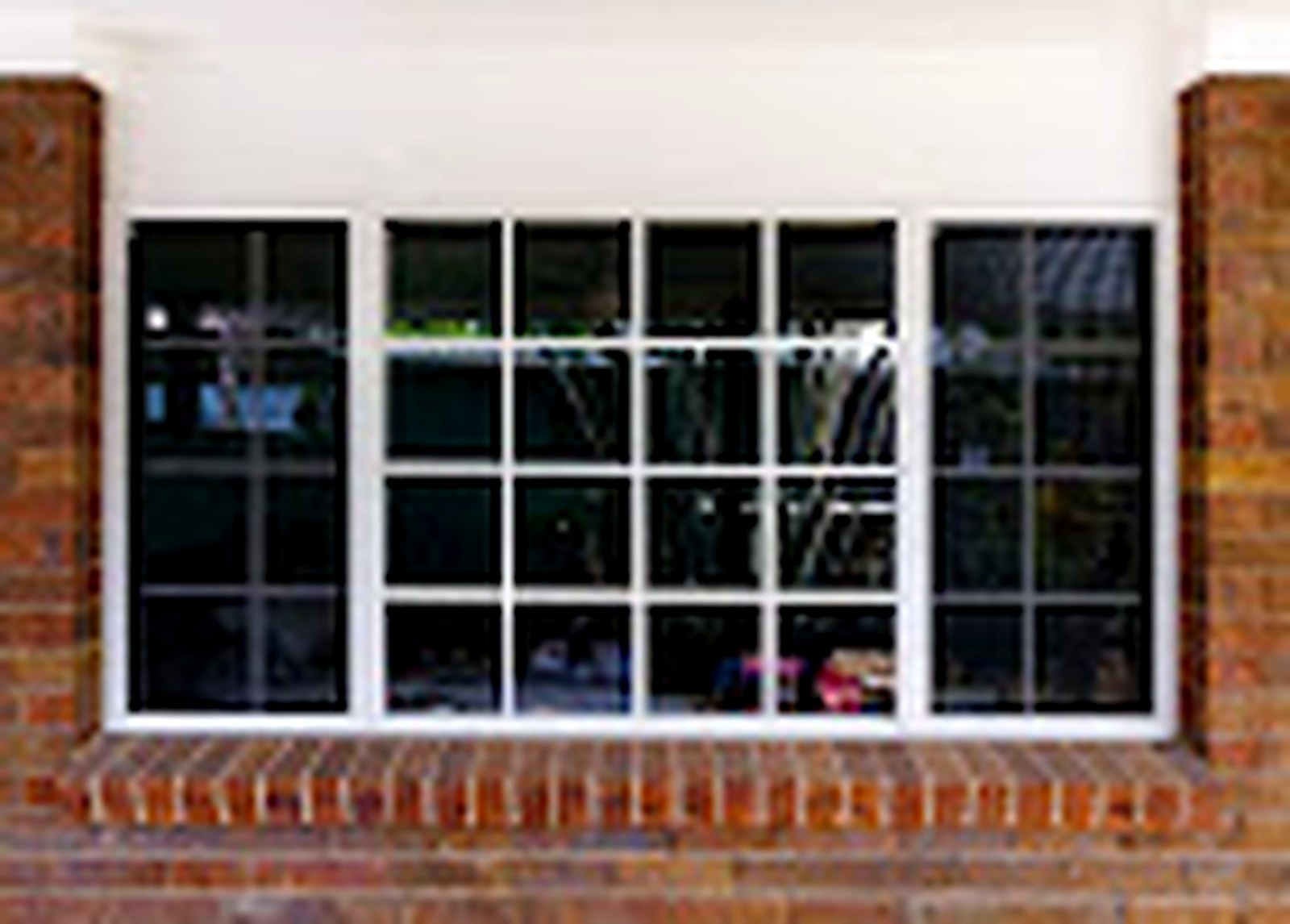 Brick home window before security screens