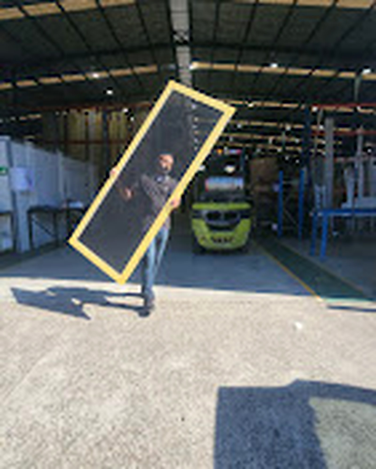 Custom screen frame being carried from the workshop