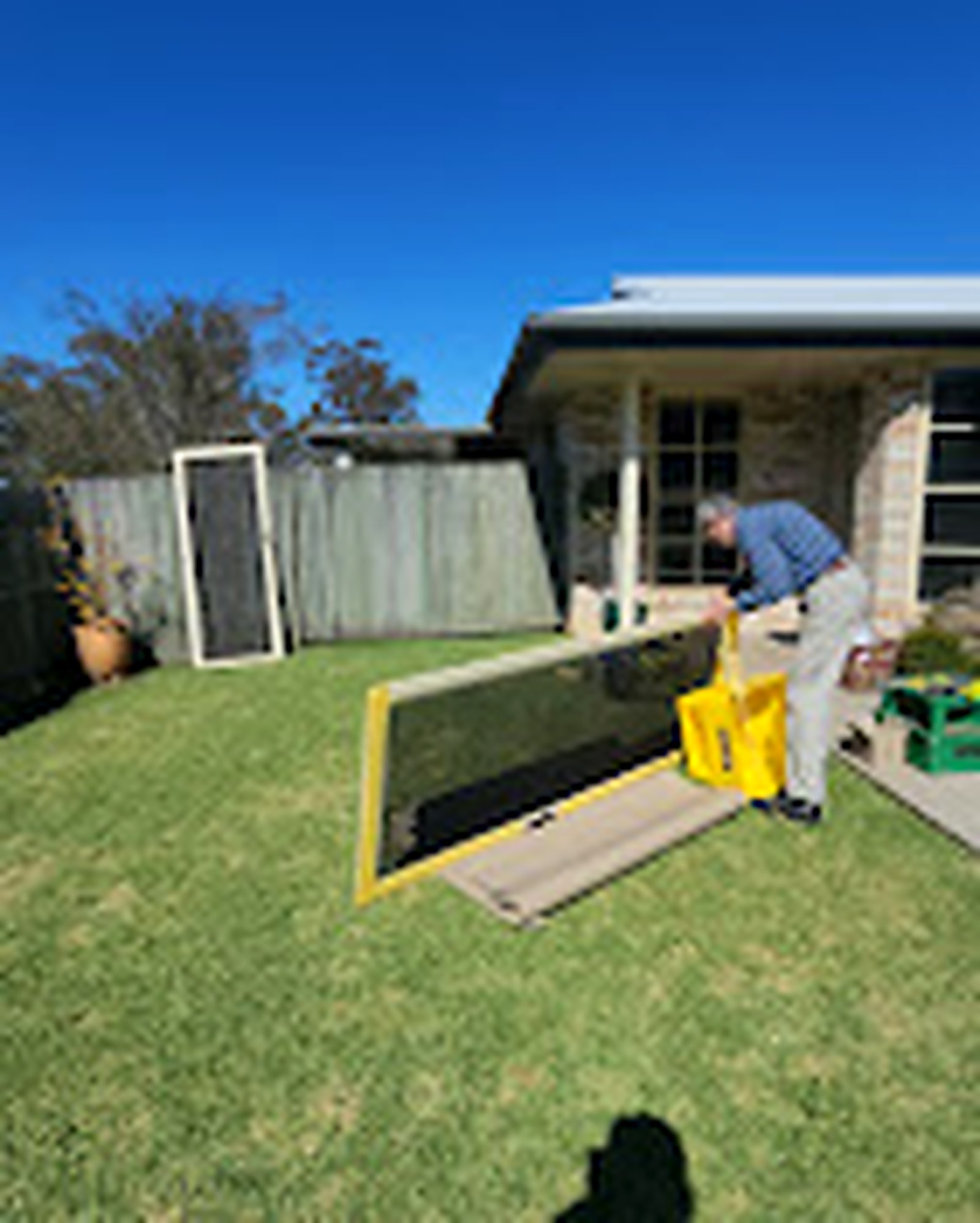 Large custom screen panel being prepared outdoors