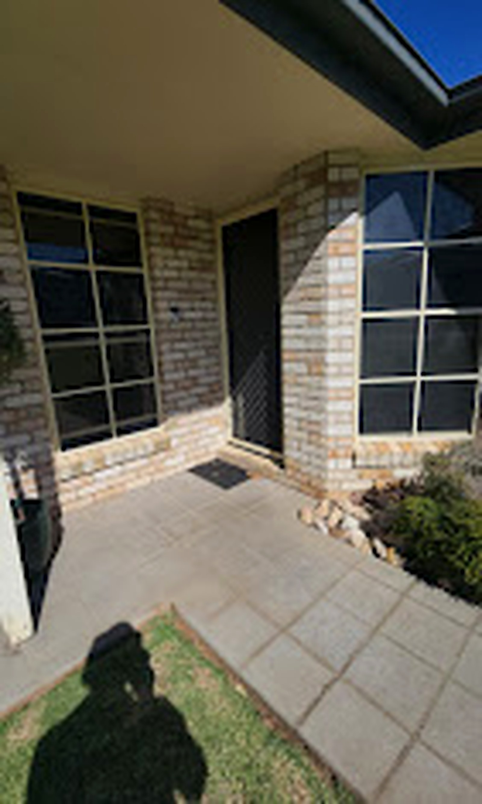 Two cleanly finished security windows at a brick home