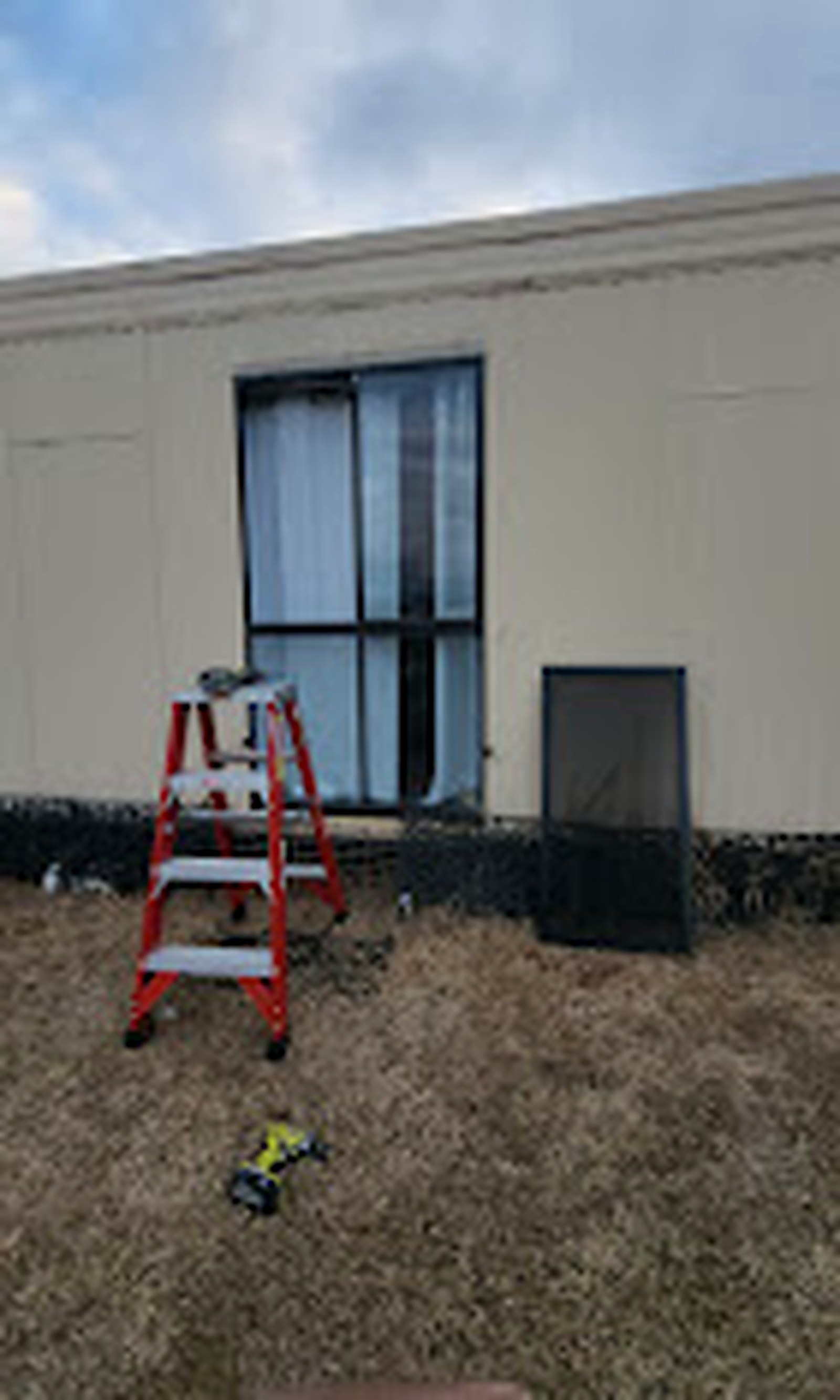 Tools and ladder beside a window installation